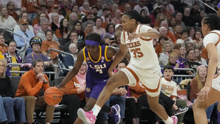 Louisiana State Lady Tigers guard Flau'jae Johnson dribbles around Texas Longhorns forward Madison Booker during the second half at Moody Center. Louisiana State Lady Tigers guard Flau'jae Johnson dribbles around Texas Longhorns forward Madison Booker during the second half at Moody Center.