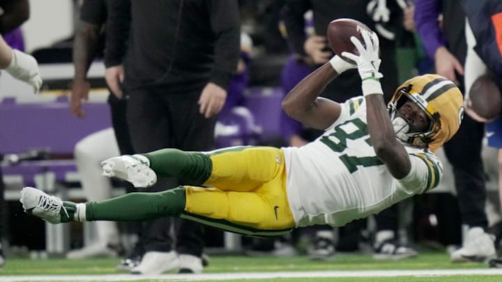 Green Bay Packers wide receiver Romeo Doubs tries to make a tumbling catch against the Vikings.