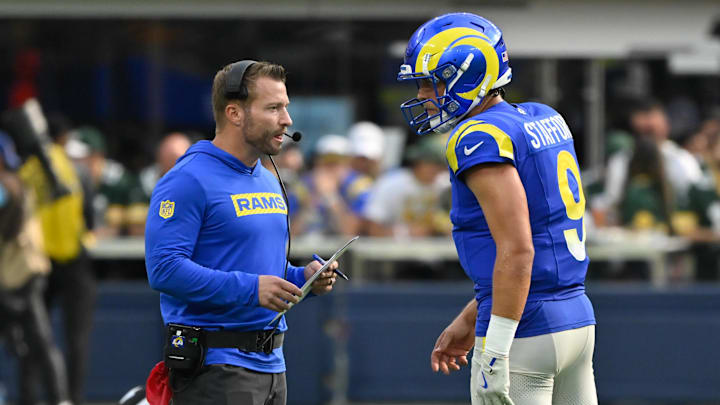 Oct 6, 2024; Inglewood, California, USA; Los Angeles Rams head coach Sean McVay talks to quarterback Matthew Stafford (9) during the third quarter against the Green Bay Packers at SoFi Stadium. Mandatory Credit: Robert Hanashiro-Imagn Images