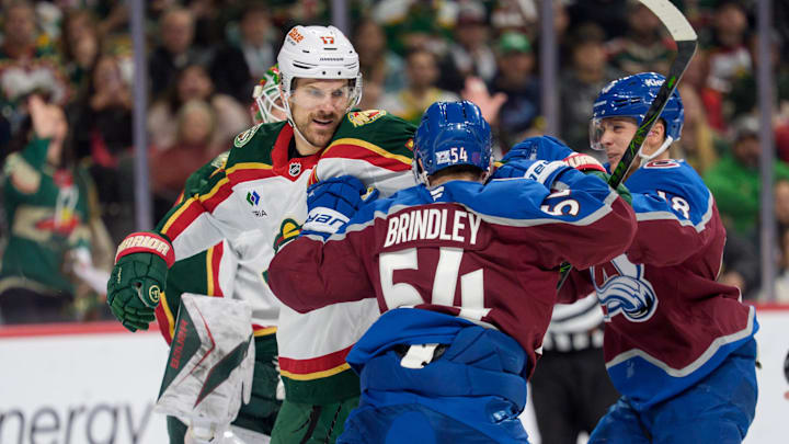 Dec 21, 2025; Saint Paul, Minnesota, USA; Colorado Avalanche center Gavin Brindley (54) and Minnesota Wild left wing Marcus Foligno (17) fight in the second period at Grand Casino Arena. Mandatory Credit: Matt Blewett-Imagn Images