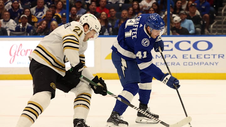 Mar 27, 2024; Tampa, Florida, USA; Tampa Bay Lightning right wing Mitchell Chaffee (41) scores a goal as Boston Bruins left wing James van Riemsdyk (21) attempted to defend during the first period at Amalie Arena. Mandatory Credit: Kim Klement Neitzel-Imagn Images