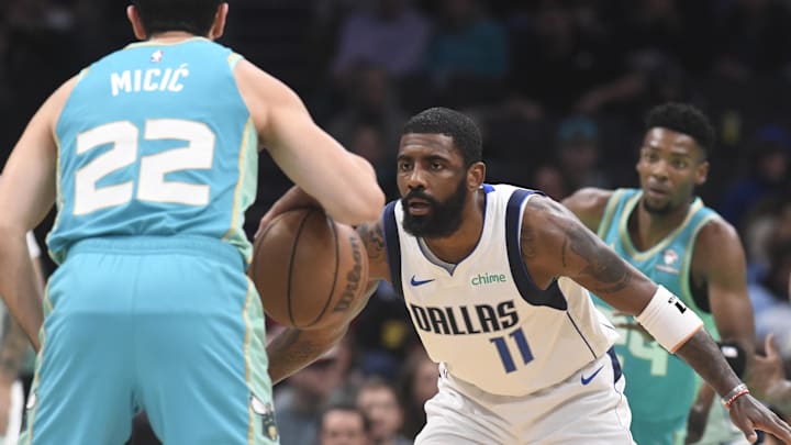 Apr 9, 2024; Charlotte, North Carolina, USA;  Dallas Mavericks guard Kyrie Irving (11) defends Charlotte Hornets guard Vasa Micic (22) during the first half at the Spectrum Center. Mandatory Credit: Sam Sharpe-Imagn Images