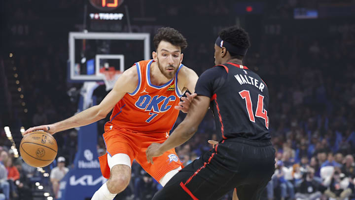 Jan 25, 2026; Oklahoma City, Oklahoma, USA;  Oklahoma City Thunder center/forward Chet Holmgren (7) moves the ball down the court as Toronto Raptors guard Ja'kobe Walter (14) defends during the first quarter at Paycom Center. Mandatory Credit: Alonzo Adams-Imagn Images