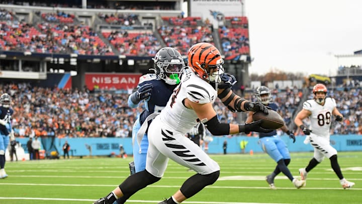 Dec 15, 2024; Nashville, Tennessee, USA;  Cincinnati Bengals defensive end Sam Hubbard (94) makes a touchdown catch over Tennessee Titans linebacker James Williams (52) during the first half at Nissan Stadium. Mandatory Credit: Steve Roberts-Imagn Images