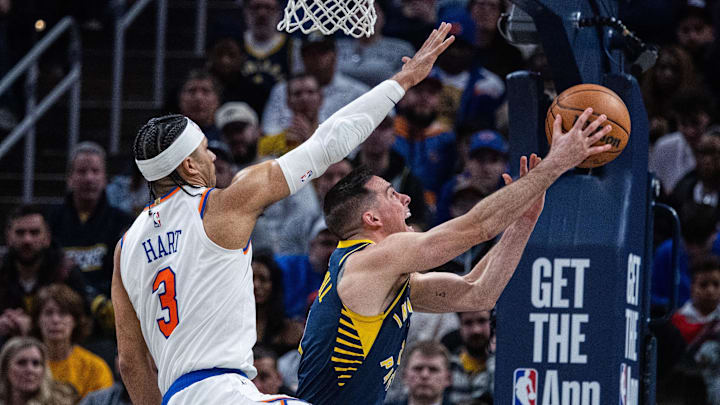 Feb 11, 2025; Indianapolis, Indiana, USA; Indiana Pacers guard T.J. McConnell (9) shoots the ball while New York Knicks guard Josh Hart (3) defends in the second half at Gainbridge Fieldhouse. Mandatory Credit: Trevor Ruszkowski-Imagn Images