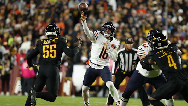 Oct 13, 2025; Landover, Maryland, USA; Chicago Bears quarterback Caleb Williams (18) passes the ball under pressure from Washington Commanders defensive end Jacob Martin (55) during the second quarter at Northwest Stadium. Mandatory Credit: Geoff Burke-Imagn Images
