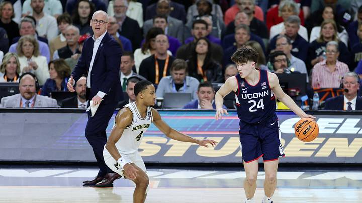 Apr 6, 2026; Indianapolis, IN, USA; UConn Huskies guard Braylon Mullins (24) dribbles the ball against Michigan Wolverines guard Nimari Burnett (4) in the second half during the national championship of the Final Four of the men's 2026 NCAA Tournament at Lucas Oil Stadium. Mandatory Credit: Trevor Ruszkowski-Imagn Images Apr 6, 2026; Indianapolis, IN, USA; UConn Huskies guard Braylon Mullins (24) dribbles the ball against Michigan Wolverines guard Nimari Burnett (4) in the second half during the national championship of the Final Four of the men's 2026 NCAA Tournament at Lucas Oil Stadium. Mandatory Credit: Trevor Ruszkowski-Imagn Images