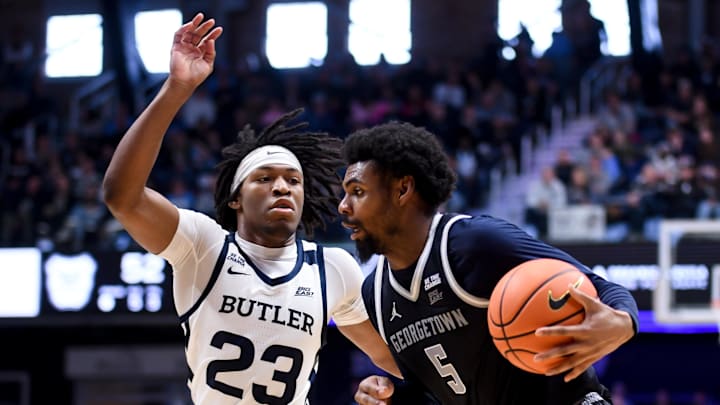 Jan 31, 2026; Indianapolis, Indiana, USA; Georgetown Hoyas guard KJ Lewis (5) drives against Butler Bulldogs guard Azavier Robinson (23) during the second half at Hinkle Fieldhouse. Mandatory Credit: Robert Goddin-Imagn Images
