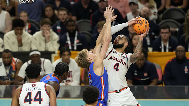 Apr 5, 2025; San Antonio, TX, USA; Auburn Tigers forward Johni Broome (4) shoots the ball on Florida Gators forward Thomas Haugh (10) during the second half in the semifinals of the men's Final Four of the 2025 NCAA Tournament at Alamodome. Mandatory Credit: Scott Wachter-Imagn Images

