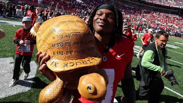 Sep 26, 2026; Columbus, Ohio, USA;  Ohio State Buckeyes wide receiver Jeremiah Smith (4) with Illibuck, a trophy awarded to the winner of the college football rivalry between the Illinois Fighting Illini and the Buckeyes, after the game at Ohio Stadium.  Mandatory Credit: Joseph Maiorana-Imagn Images