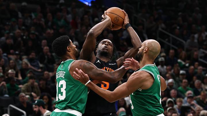Oct 23, 2026; Boston, Massachusetts, USA; New York Knicks forward Og Anunoby (8) tries to get between Boston Celtics forward Paul George (13) and guard Derrick White (9) during the first quarter at TD Garden. Mandatory Credit: Winslow Townson-Imagn Images