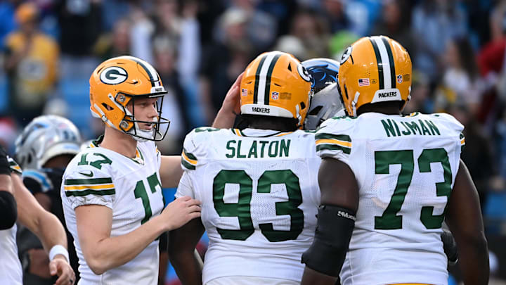 Dec 24, 2023; Charlotte, North Carolina, USA; Green Bay Packers place kicker Anders Carlson (17) with defensive tackle T.J. Slaton (93) and offensive tackle Yosh Nijman (73) after kicking the game winning field goal in the fourth quarter at Bank of America Stadium. Mandatory Credit: Bob Donnan-Imagn Images
