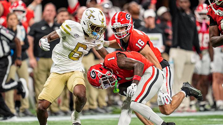 Nov 28, 2025; Atlanta, Georgia, USA; Georgia Bulldogs wide receiver Zachariah Branch (1) ducks under a tackle by Georgia Tech Yellow Jackets defensive back Rodney Shelley (6) during the first half at Mercedes-Benz Stadium. Mandatory Credit: Dale Zanine-Imagn Images Nov 28, 2025; Atlanta, Georgia, USA; Georgia Bulldogs wide receiver Zachariah Branch (1) ducks under a tackle by Georgia Tech Yellow Jackets defensive back Rodney Shelley (6) during the first half at Mercedes-Benz Stadium. Mandatory Credit: Dale Zanine-Imagn Images