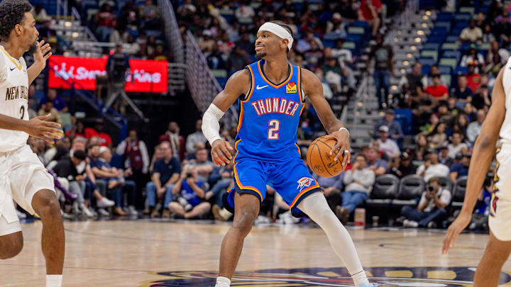 Nov 17, 2025; New Orleans, Louisiana, USA;  Oklahoma City Thunder guard Shai Gilgeous-Alexander (2) dribbles against New Orleans Pelicans center Derik Queen (22) during the first half at Smoothie King Center. Mandatory Credit: Stephen Lew-Imagn Images