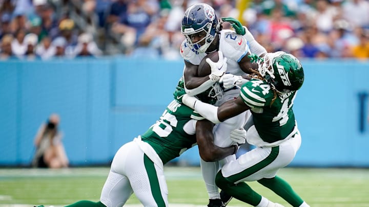 Tennessee Titans running back Tyjae Spears (2) is tackled by New York Jets linebacker Quincy Williams (56) linebacker Jamien Sherwood (44) during the second quarter at Nissan Stadium in Nashville, Tenn., Sunday, Sept. 15, 2024.