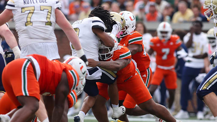 Nov 9, 2024; Atlanta, Georgia, USA; Miami Hurricanes defensive lineman Ahmad Moten Sr. (99) targets Georgia Tech Yellow Jackets running back Trey Cooley (3) in the third quarter at Bobby Dodd Stadium at Hyundai Field. Mandatory Credit: Brett Davis-Imagn Images