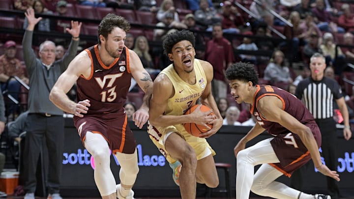 Jan 29, 2025; Tallahassee, Florida, USA; Florida State Seminoles guard Bostyn Holt (3) drives to the net past Virginia Tech Hokies forward Ben Burnham (13) during the first half at Donald L. Tucker Center. Mandatory Credit: Melina Myers-Imagn Images