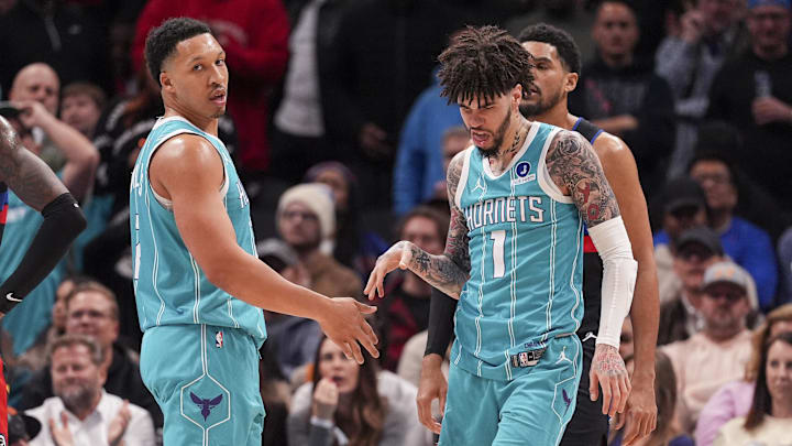 Feb 9, 2026; Charlotte, North Carolina, USA; Charlotte Hornets guard LaMelo Ball (1) and forward Grant Williams (2) after a thee point play against the Detroit Pistons during the second half at Spectrum Center. Mandatory Credit: Jim Dedmon-Imagn Images