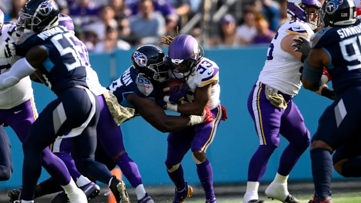 Nov 17, 2024; Nashville, Tennessee, USA; Tennessee Titans defensive tackle Sebastian Joseph-Day (69) tackles Minnesota Vikings running back Aaron Jones (33) for a loss during the first half at Nissan Stadium. Mandatory Credit: Steve Roberts-Imagn Images