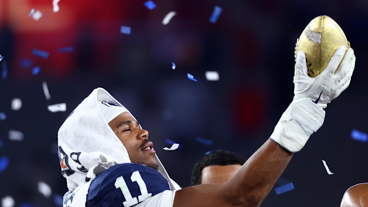 Dec 31, 2024; Glendale, AZ, USA; Penn State Nittany Lions defensive end Abdul Carter (11) reacts with the trophy after the game against the Boise State Broncos in the Fiesta Bowl at State Farm Stadium. Mandatory Credit: Mark J. Rebilas-Imagn Images