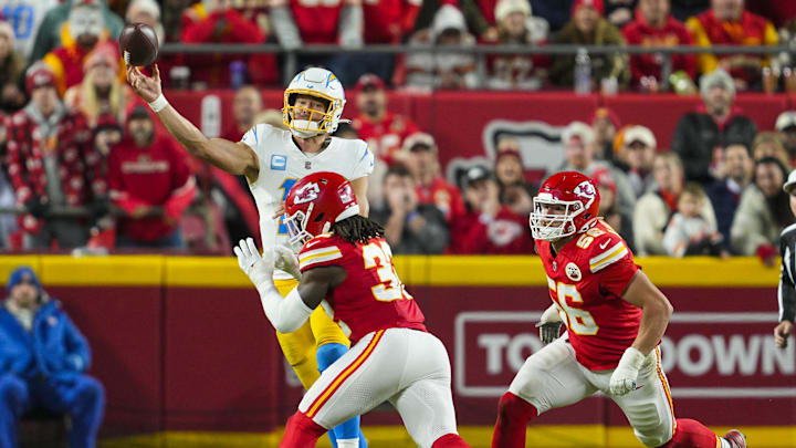 Dec 8, 2024; Kansas City, Missouri, USA; Los Angeles Chargers quarterback Justin Herbert (10) throws a pass against Kansas City Chiefs linebacker Nick Bolton (32) during the first half at GEHA Field at Arrowhead Stadium. Mandatory Credit: Jay Biggerstaff-Imagn Images