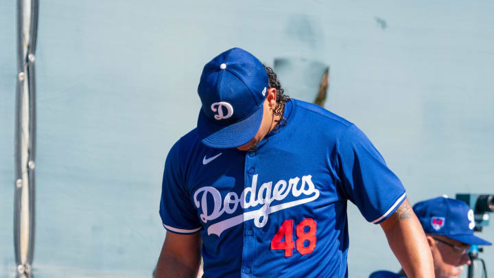 Feb 11, 2024; Glendale, AZ, USA; Los Angeles Dodgers pitcher Brusdar Graterol (48) works alongside members of his team on the practice mound at Camelback Ranch during Spring Training Workouts. Mandatory Credit: Allan Henry-USA TODAY Sports