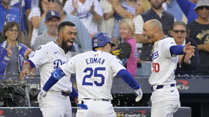 Oct 26, 2024; Los Angeles, California, USA; Los Angeles Dodgers shortstop Tommy Edman (25) celebrates with outfielder Teoscar Hernandez (37) and outfielder Mookie Betts (50) after hitting a solo home run in the second inning against the New York Yankees during game two of the 2024 MLB World Series at Dodger Stadium. Mandatory Credit: Jayne Kamin-Oncea-Imagn Images