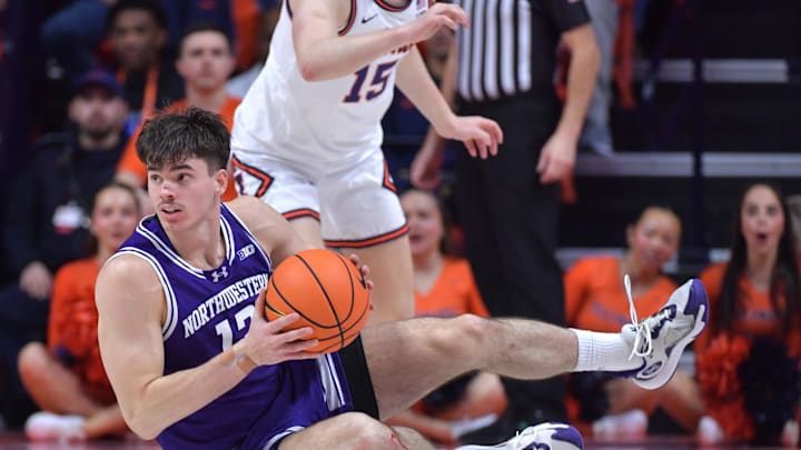 Jan 26, 2025; Champaign, Illinois, USA;  Northwestern Wildcats guard Brooks Barnhizer (13) grabs the ball off the court during the first half against the Illinois Fighting Illini at State Farm Center. Mandatory Credit: Ron Johnson-Imagn Images