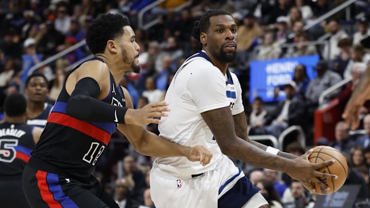 Jan 4, 2025; Detroit, Michigan, USA;  Minnesota Timberwolves center Naz Reid (11) dribbles defended by Detroit Pistons forward Tobias Harris (12) in the second half at Little Caesars Arena. Mandatory Credit: Rick Osentoski-Imagn Images