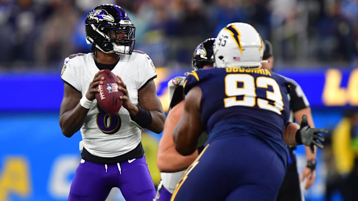 Nov 26, 2023; Inglewood, California, USA; Baltimore Ravens quarterback Lamar Jackson (8) drops back to pass against the Los Angeles Chargers during the first half at SoFi Stadium. Mandatory Credit: Gary A. Vasquez-Imagn Images