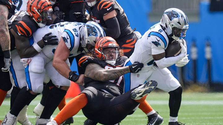 Sep 29, 2024; Charlotte, North Carolina, USA; Cincinnati Bengals defensive tackle Jay Tufele (97) tackles Carolina Panthers running back Miles Sanders (6) during the second quarter at Bank of America Stadium. Mandatory Credit: Jim Dedmon-Imagn Images