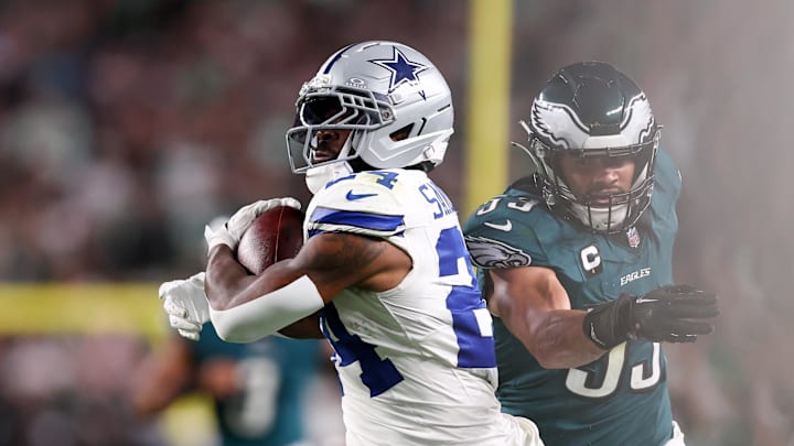 Sep 4, 2025; Philadelphia, Pennsylvania, USA; Dallas Cowboys running back Miles Sanders (24) avoids a tackle by Philadelphia Eagles linebacker Zack Baun (53) during the third quarter of the game at Lincoln Financial Field. Mandatory Credit: Bill Streicher-Imagn Images