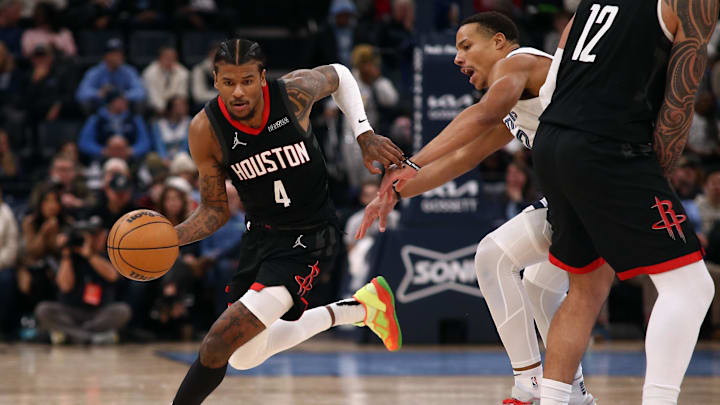 Jan 9, 2025; Memphis, Tennessee, USA; Houston Rockets guard Jalen Green (4) dribbles around a screen as Memphis Grizzlies guard Desmond Bane (22) defends during the fourth quarter at FedExForum. Mandatory Credit: Petre Thomas-Imagn Images