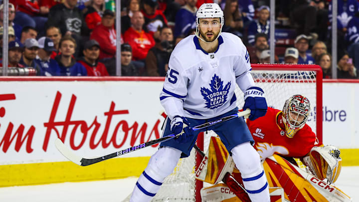Feb 2, 2026; Calgary, Alberta, CAN; Toronto Maple Leafs center Nicolas Roy (55) screens in front of Calgary Flames goaltender Dustin Wolf (32) during the third period at Scotiabank Saddledome. Mandatory Credit: Sergei Belski-Imagn Images