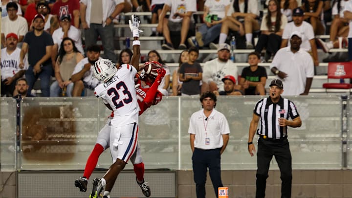 Aug 31, 2024; Tucson, Arizona, USA; Arizona Wildcats defensive back Emmanuel Karnley (23) fails to deflect catch made by New Mexico wide receiver Luke Wysong (15) during fourth quarter at Arizona Stadium. Mandatory Credit: Aryanna Frank-Imagn Images