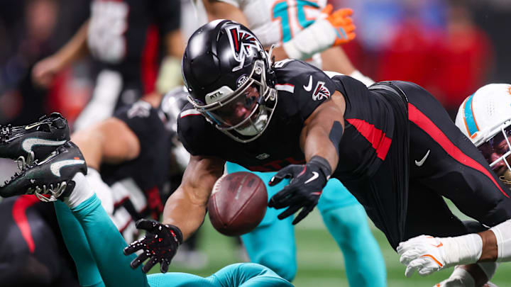 Oct 26, 2025; Atlanta, Georgia, USA; Atlanta Falcons running back Bijan Robinson (7) fumbles against the Miami Dolphins in the third quarter at Mercedes-Benz Stadium. Mandatory Credit: Brett Davis-Imagn Images
