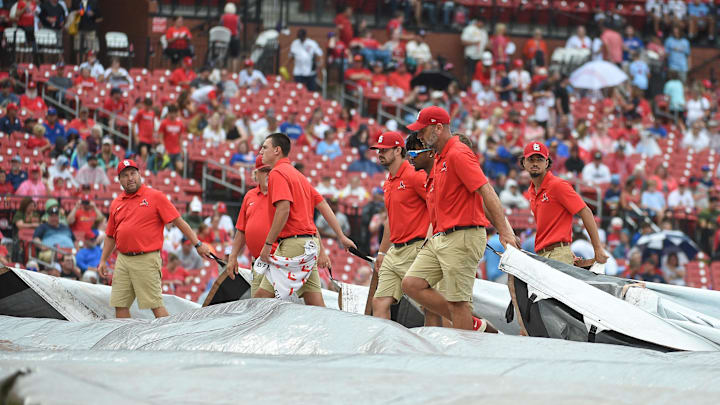 Sep 4, 2022; St. Louis, Missouri, USA; Grounds crew putting the tarp on the field during a rain delay prior to a game between the St. Louis Cardinals and the Chicago Cubs at Busch Stadium. Mandatory Credit: Joe Puetz-Imagn Images