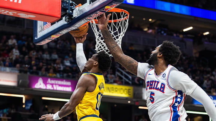 Jan 18, 2025; Indianapolis, Indiana, USA; Indiana Pacers guard Bennedict Mathurin (00) shoots the ball while Philadelphia 76ers center Andre Drummond (5) defends in the first half at Gainbridge Fieldhouse. Mandatory Credit: Trevor Ruszkowski-Imagn Images Jan 18, 2025; Indianapolis, Indiana, USA; Indiana Pacers guard Bennedict Mathurin (00) shoots the ball while Philadelphia 76ers center Andre Drummond (5) defends in the first half at Gainbridge Fieldhouse. Mandatory Credit: Trevor Ruszkowski-Imagn Images