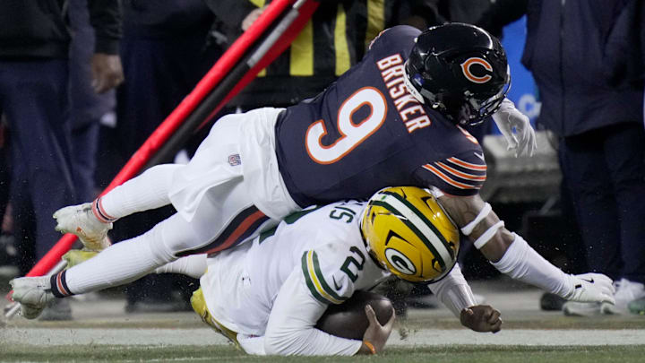 Jaquan Brisker gets penalized for a late hit on sliding Malik Willis. Brisker could not practice Friday due to illness.