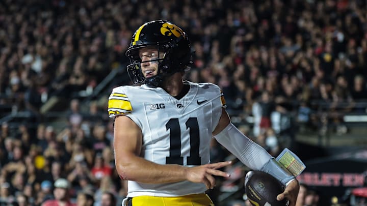 Sep 19, 2025; Piscataway, New Jersey, USA; Iowa Hawkeyes quarterback Mark Gronowski (11) celebrates after scoring a rushing touchdown during the first half against the Rutgers Scarlet Knights at SHI Stadium. Mandatory Credit: Vincent Carchietta-Imagn Images