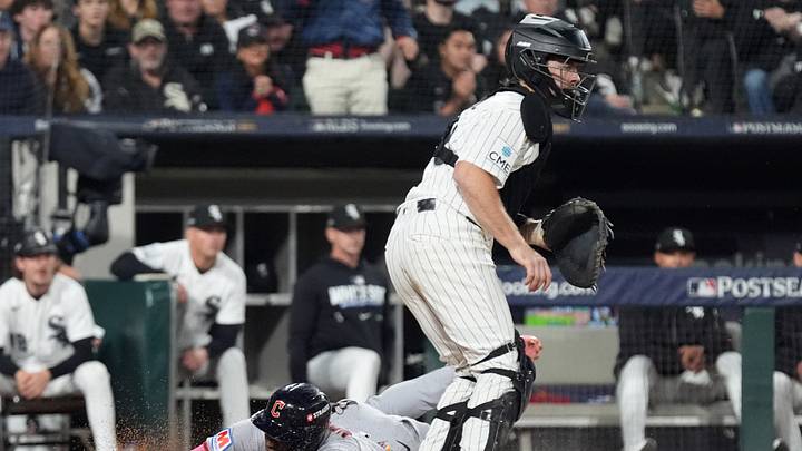 Oct 8, 2026; Chicago, Illinois, USA;  Cleveland Guardians left fielder Angel Martinez (1) scores as Chicago White Sox catcher Kyle Teel (8) waits for the throw during the sixth inning in game four of the ALDS for the 2026 MLB Playoffs at Rate Field.  Mandatory Credit: David Banks-Imagn Images