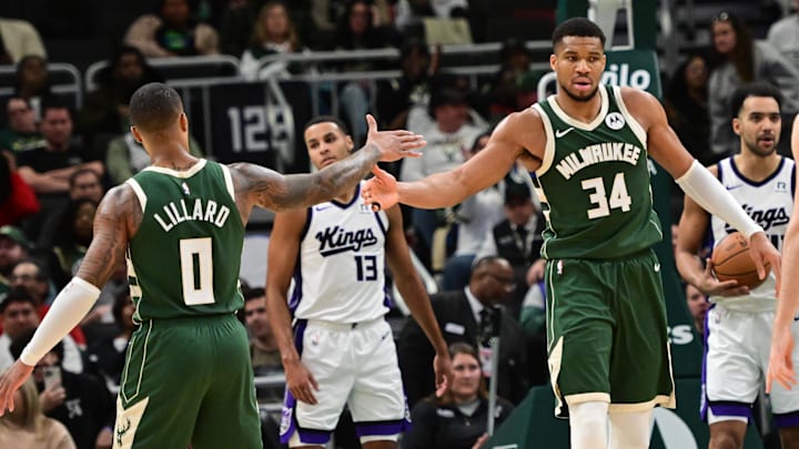 Jan 14, 2025; Milwaukee, Wisconsin, USA; Milwaukee Bucks forward Giannis Antetokounmpo (34) reacts with guard Damian Lillard (0) after scoring a basket in the second quarter against the Sacramento Kings at Fiserv Forum. Mandatory Credit: Benny Sieu-Imagn Images