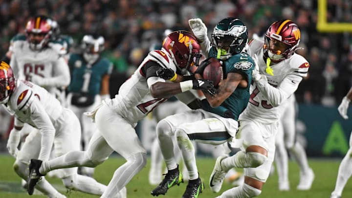 Nov 14, 2024; Philadelphia, Pennsylvania, USA; Philadelphia Eagles wide receiver DeVonta Smith (6) is tackled by Washington Commanders safety Quan Martin (20) and cornerback Benjamin St-Juste (25) during the second quarter at Lincoln Financial Field. Mandatory Credit: Eric Hartline-Imagn Images
