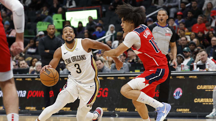 Jan 5, 2025; Washington, District of Columbia, USA; New Orleans Pelicans guard CJ McCollum (3) drives to the basket as Washington Wizards forward Kyshawn George (18) defends in the fourth quarter at Capital One Arena. Mandatory Credit: Geoff Burke-Imagn Images