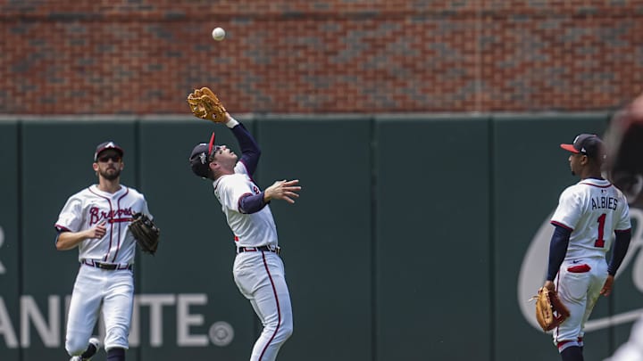 May 15, 2025; Cumberland, Georgia, USA; Atlanta Braves shortstop Nick Allen (2) catches a fly ball between outfielder outfielder Eli White (36) and second base Ozzie Albies (1) against the Washington Nationals during the second inning at Truist Park. Mandatory Credit: Dale Zanine-Imagn Images