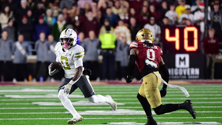 Nov 15, 2025; Chestnut Hill, Massachusetts, USA; Georgia Tech Yellow Jackets running back Malachi Hosley (0) runs the ball while Boston College Eagles defensive back Omar Thornton (0) defends during the second half at Alumni Stadium. Mandatory Credit: Bob DeChiara-Imagn Images