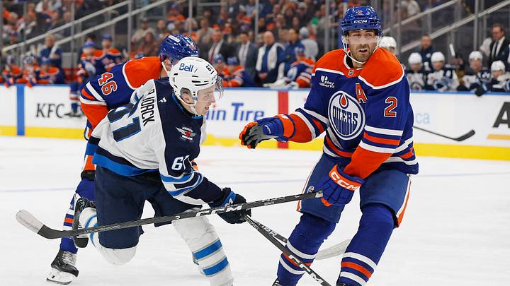 Sep 19, 2026; Edmonton, Alberta, CAN;  Winnipeg Jets forward Viggo Bjorck (61) takes a shot in front of Edmonton Oilers defensemen Evan Bouchard (2) during the second period at Rogers Place.  Mandatory Credit: Perry Nelson-Imagn Images