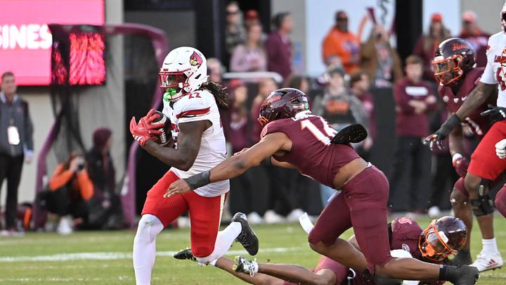 Nov 1, 2025; Blacksburg, Virginia, USA; Virginia Tech Hokies linebacker Noah Chambers (16) tackles Louisville Cardinals running back Keyjuan Brown (22) during the fourth quarter at Lane Stadium. Mandatory Credit: Brian Bishop-Imagn Images Nov 1, 2025; Blacksburg, Virginia, USA; Virginia Tech Hokies linebacker Noah Chambers (16) tackles Louisville Cardinals running back Keyjuan Brown (22) during the fourth quarter at Lane Stadium. Mandatory Credit: Brian Bishop-Imagn Images