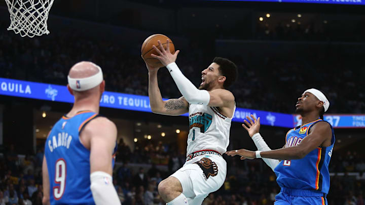 Apr 24, 2025; Memphis, Tennessee, USA; Memphis Grizzlies guard Scotty Pippen Jr. (1) drives to the basket as Oklahoma City Thunder guard Shai Gilgeous-Alexander (2) defends during the second quarter during game three for the first round of the 2024 NBA Playoffs at FedExForum. Mandatory Credit: Petre Thomas-Imagn Images