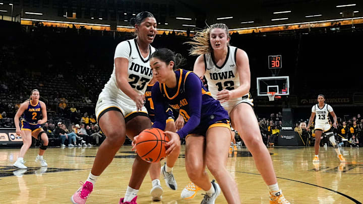 Ashland guard Alysa Lopez (0) races Iowa forward Jada Gyamfi (23) and Iowa center Layla Hays (12) to a loose ball Oct. 30, 2025 during an exhibition game at Carver-Hawkeye Arena in Iowa City, Iowa.